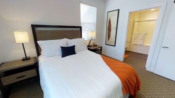 Yolo apartments furnished bedroom with plush carpeting